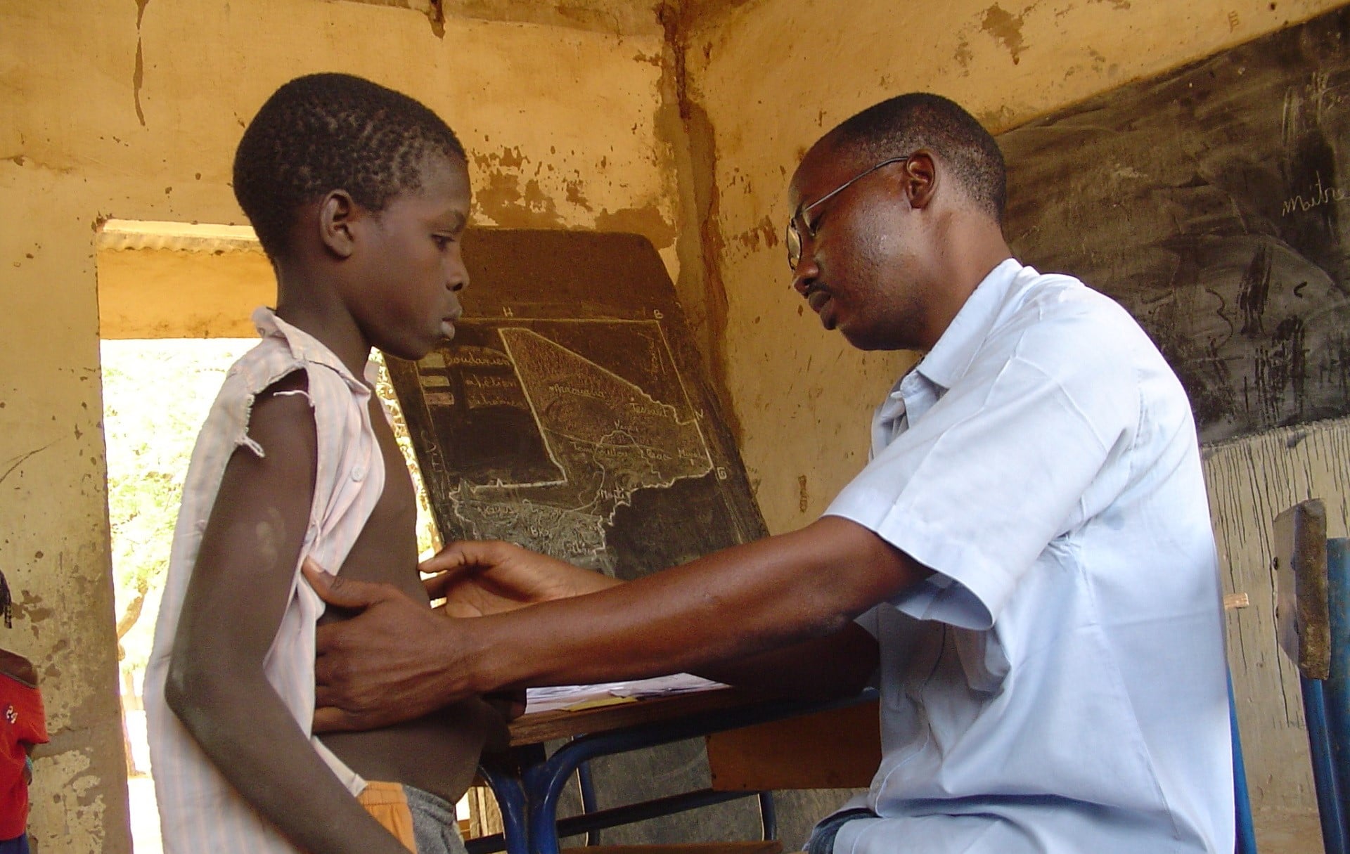 A man examining a child