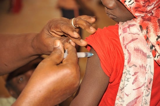 Health worker administers a vaccine